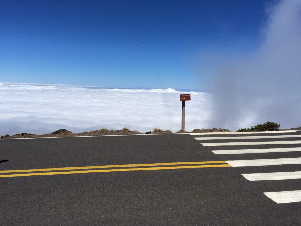 Crosswalk and road disappearing into the clouds on Haleakala National Park, Maui, Hawaii.