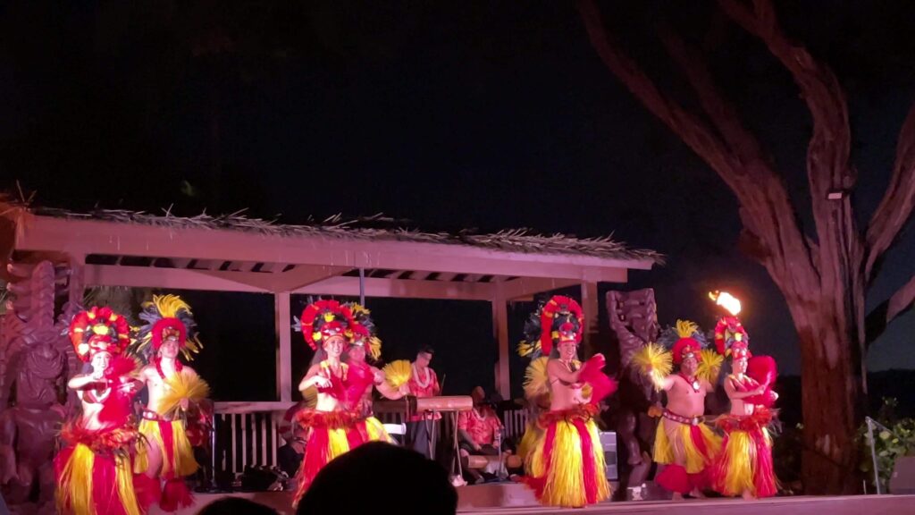 Hula dancers in red and yellow at the Sheraton Kaanapali Luau Maui
