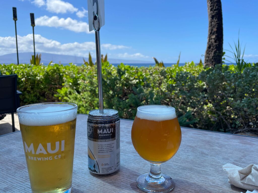 Two Maui Brewing Company beers on the table on the beach at Kaanapali, Maui, Hawaii