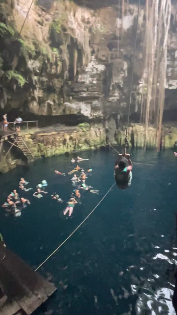 Rope swinging at cenote on Chichen Itza tours from Cancun