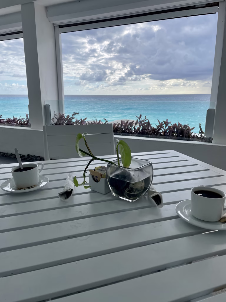 Coffee on the table at the breakfast buffet overlooking the ocean.