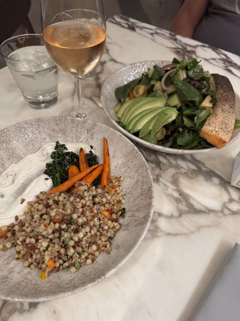 Healthy meals and glass of rose on the table at Sugar Palm Restaurant